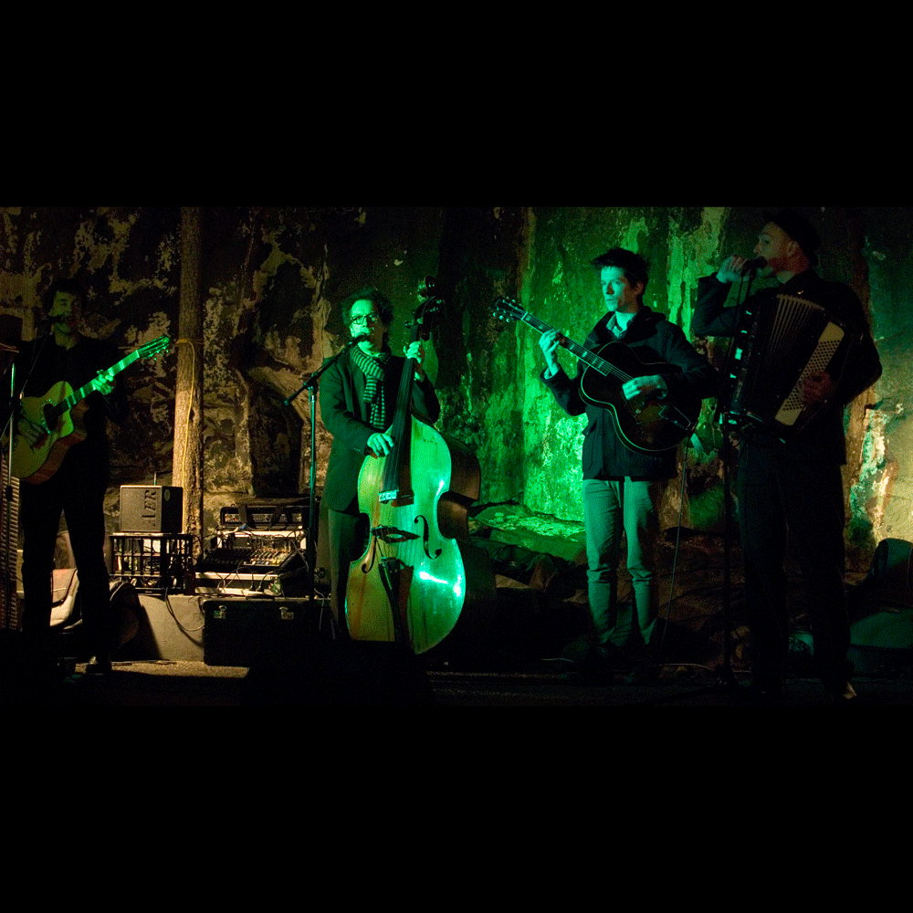 Musicians performing on a dimly lit stage